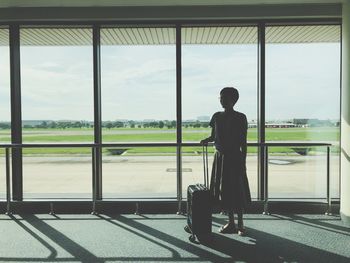 Rear view of man standing at airport