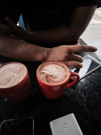 Cropped hands of woman using mobile phone