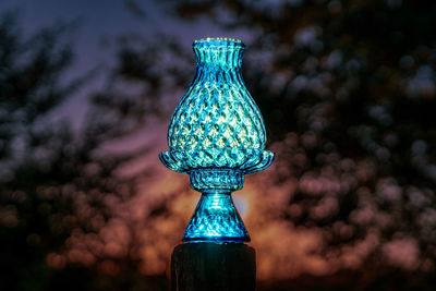 Crystal glass candle holder glowing from the sunset with abstract background and light effect