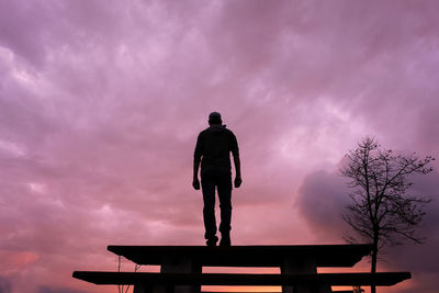 Low angle view of man standing against sky