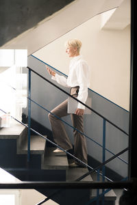 Woman standing by staircase