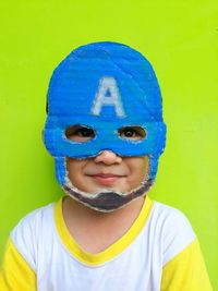 Portrait of smiling boy against blue background