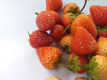 Close-up of strawberries on table against white background