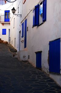 Empty narrow pathway along cropped built structures