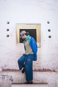 Full length of woman standing by railing