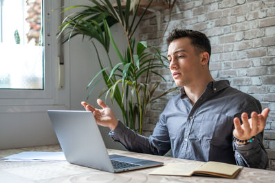 Young man using laptop at office