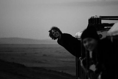 Man on beach against clear sky