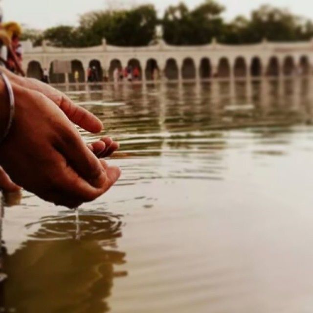 water, person, waterfront, part of, holding, reflection, cropped, focus on foreground, lifestyles, leisure activity, lake, men, rippled, unrecognizable person, close-up, river