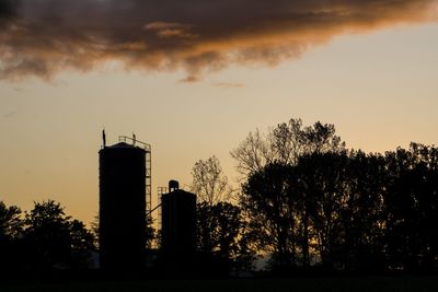 Silhouette of building against sky at sunset