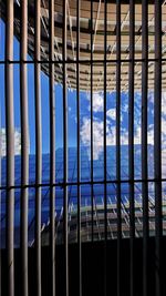 Full frame shot of building seen through metal fence