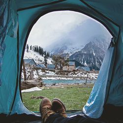 Low section of woman sitting in tent