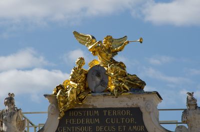 Low angle view of statue against cloudy sky