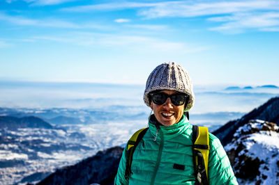 Portrait of smiling woman against land during winter