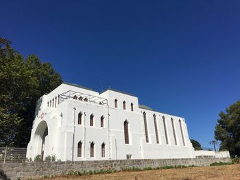 Low angle view of building against clear blue sky