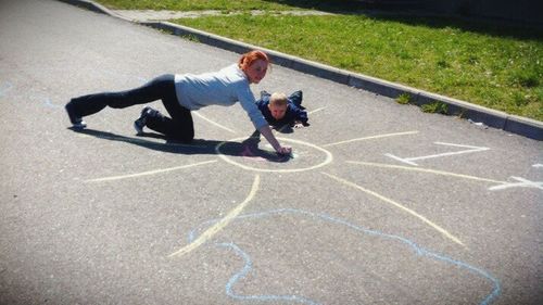 Father and son playing on grass