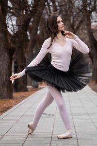 Ballerina dancing on footpath