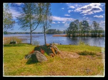 Scenic view of lake against cloudy sky