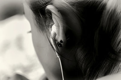 Close-up of girl listening music