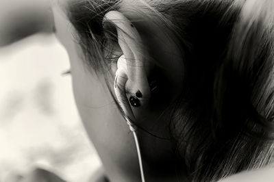 Close-up of woman listening music