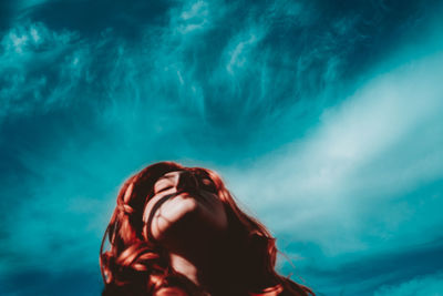 Close-up portrait of woman in swimming pool against sea