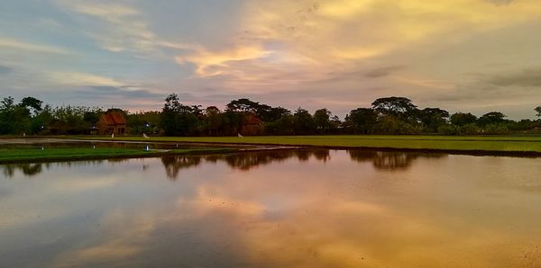 Scenic view of lake against sky during sunset