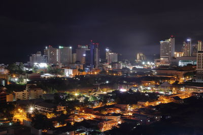 High angle view of illuminated buildings against sky at night