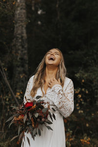 Woman standing by plant