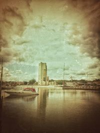 Built structure in water against cloudy sky