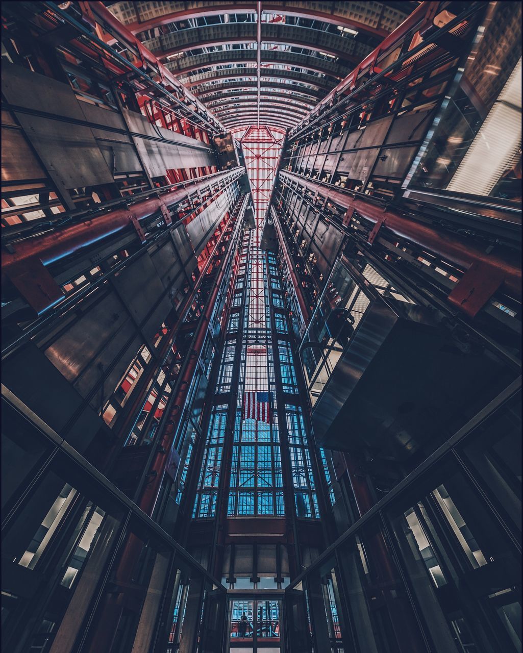 architecture, built structure, low angle view, no people, indoors, modern, building, ceiling, illuminated, tall - high, city, glass - material, pattern, architectural feature, directly below, day, metal, lighting equipment, skyscraper, luxury