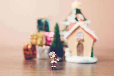 Santa claus and christmas gifts on table