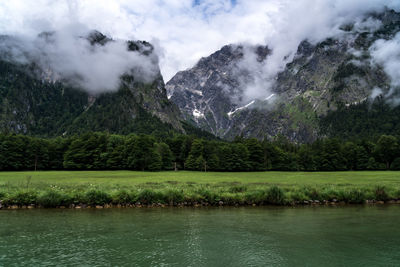 Scenic view of lake and mountains against sky