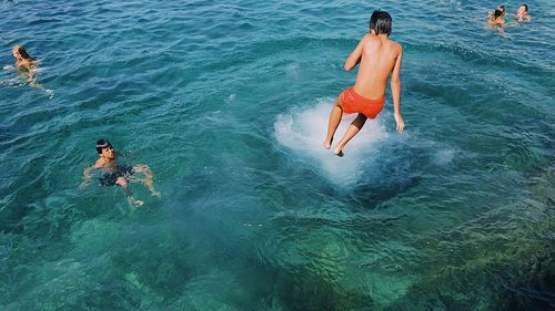 High angle view of people swimming in sea