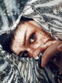 Close-up portrait of woman covering face