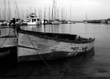 Sailboats moored in harbor