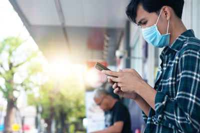 Midsection of man using mobile phone