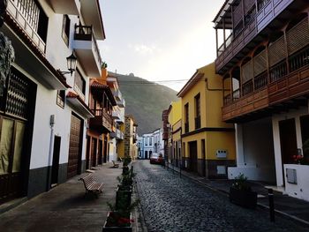 Narrow street amidst buildings in city