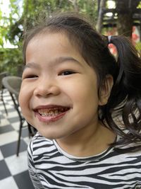 Close-up portrait of smiling girl