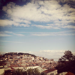 Buildings against cloudy sky