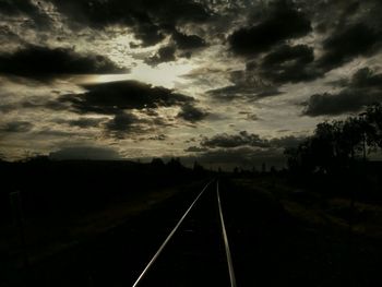 Road passing through landscape against cloudy sky