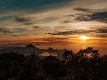 Scenic view of silhouette mountains against sky during sunset