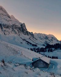 Scenic view of snow covered mountains against sky