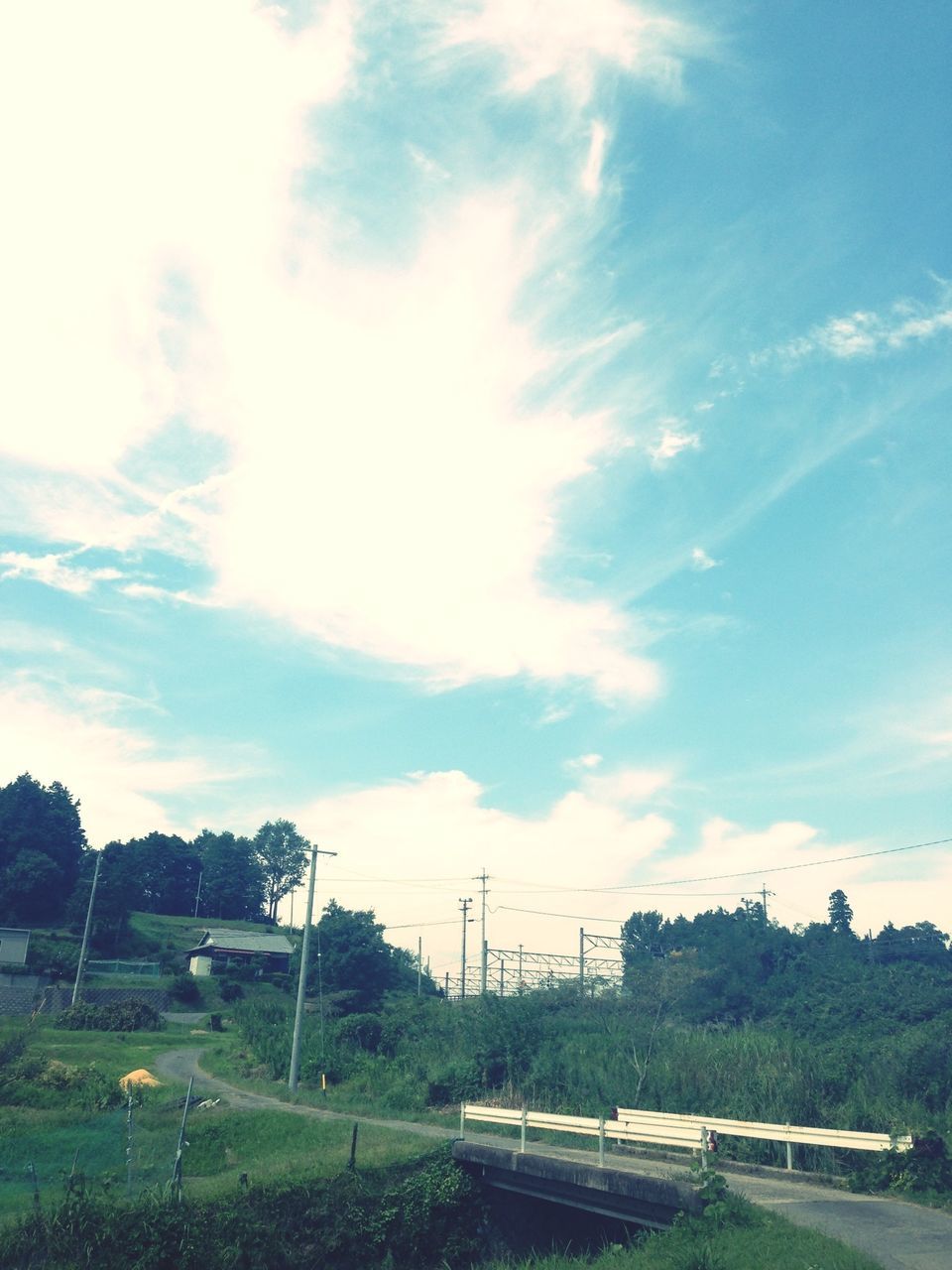 sky, landscape, cloud - sky, field, tranquility, tranquil scene, tree, cloud, nature, grass, cloudy, blue, scenics, electricity pylon, fuel and power generation, beauty in nature, day, non-urban scene, outdoors, rural scene