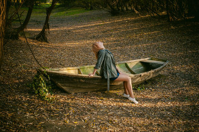 Man sitting on grass at shore