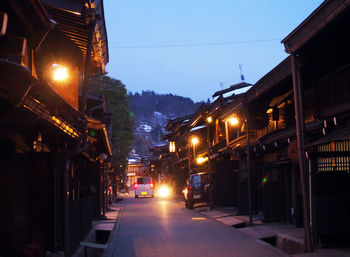 Illuminated city against clear sky at night