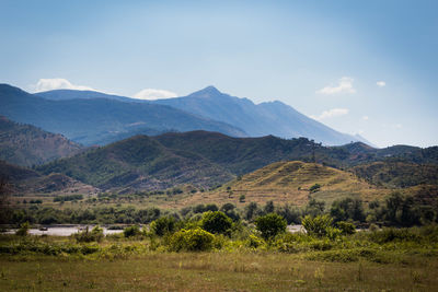 Scenic view of landscape and mountains against sky