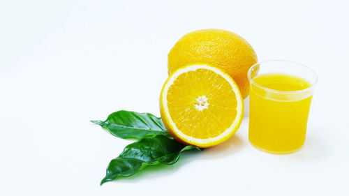 Close-up of lemon slice against white background