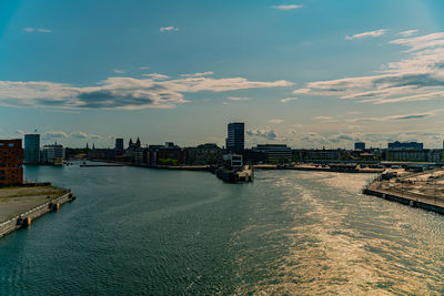 River by buildings against sky in city