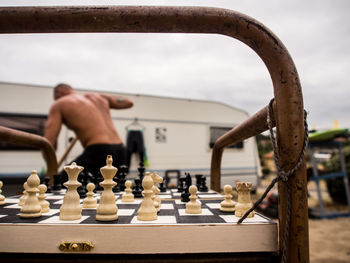 Close-up of chess pieces against the sky