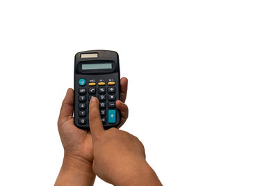 Close-up of hand holding camera over white background