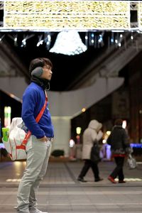 Rear view of man walking on footpath